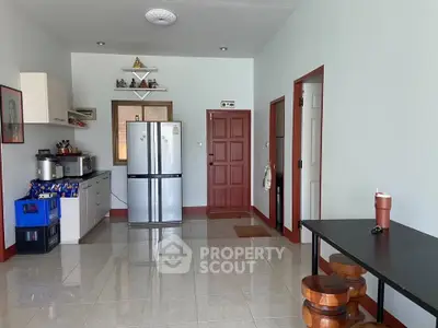 Spacious kitchen with modern appliances and dining area in a cozy home setting.