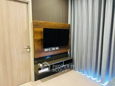 Modern living room with sleek TV setup and elegant curtains