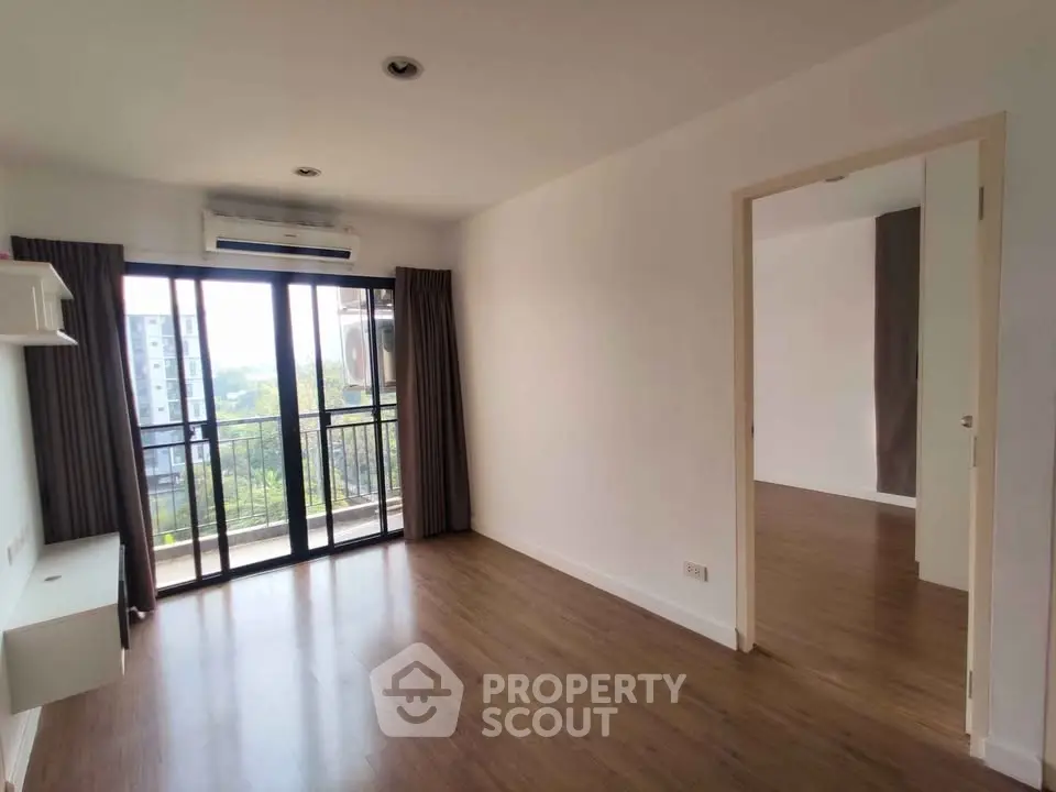 Spacious living room with balcony view in modern apartment