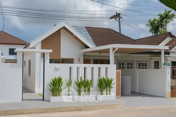 Charming modern house with sleek design and lush greenery in a serene neighborhood.