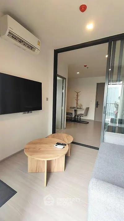 Modern living room with sleek furniture and open layout in a stylish apartment.