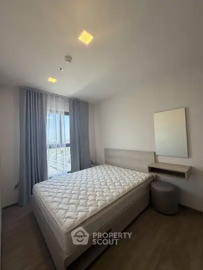 Modern bedroom with natural light and minimalist design, featuring a comfortable bed and stylish decor.