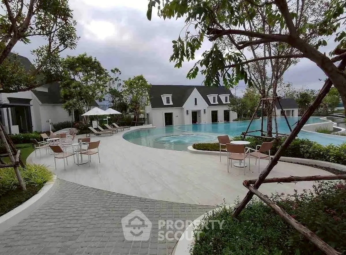 Luxurious residential pool area with modern design and lush greenery.