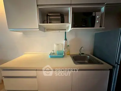 Modern kitchen with sleek cabinetry and appliances, featuring a compact design and efficient layout.