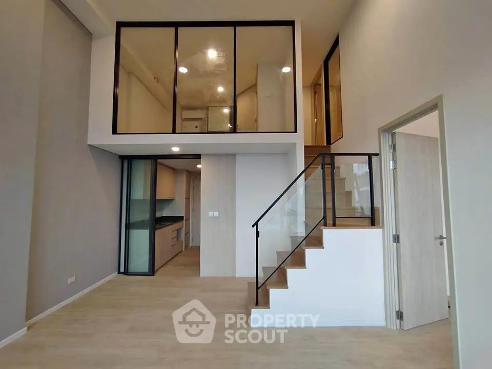 Modern duplex apartment with sleek staircase and open kitchen layout