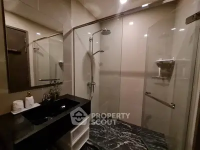 Modern bathroom with sleek design, glass shower enclosure, and elegant fixtures.