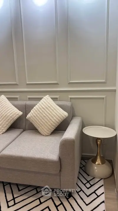 Stylish living room with modern gray sofa and chic side table, perfect for cozy relaxation.