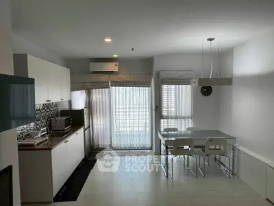 Modern open-layout kitchen and dining area with sleek design and natural light.
