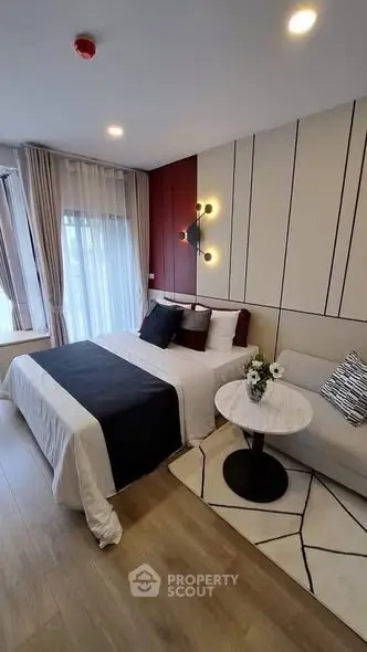 Modern bedroom with stylish decor and cozy ambiance, featuring a comfortable bed and elegant lighting.