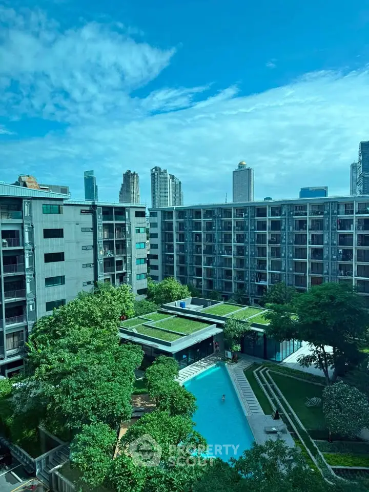 Modern apartment complex with lush greenery and inviting pool view.