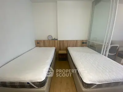 Modern twin bedroom with minimalist design and wooden flooring