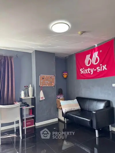 Modern living room with sleek black sofa and stylish decor