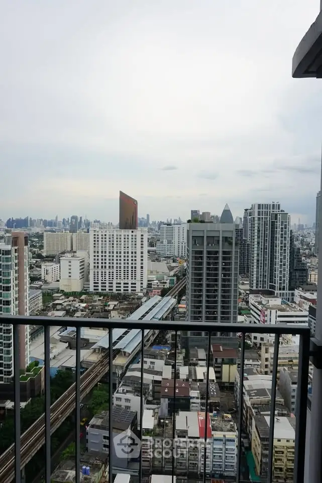 Stunning cityscape view from a high-rise balcony overlooking urban skyline and modern architecture.