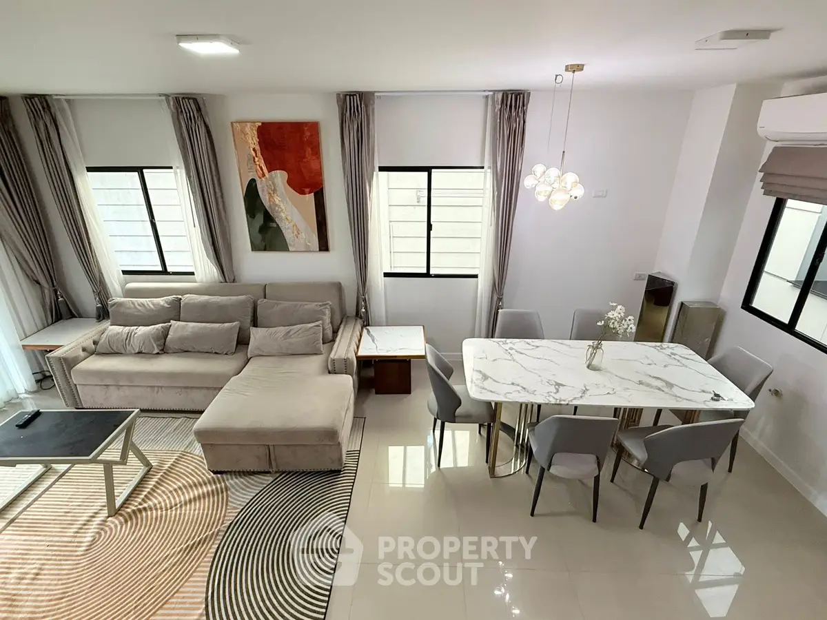 Spacious modern living and dining area with elegant decor and natural light.