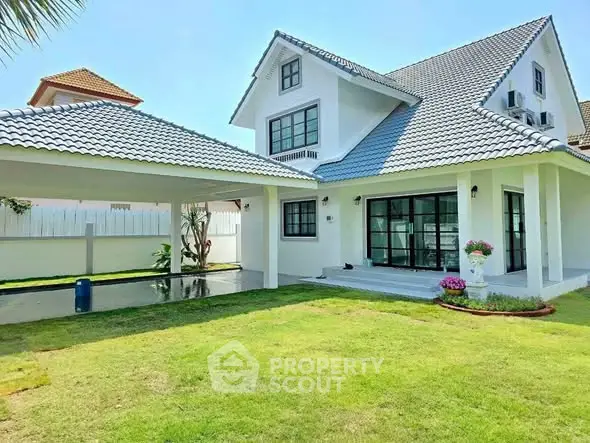 Charming modern house with spacious lawn and covered carport, perfect for family living.