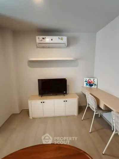 Modern living room with air conditioning and stylish furniture, perfect for comfortable living.