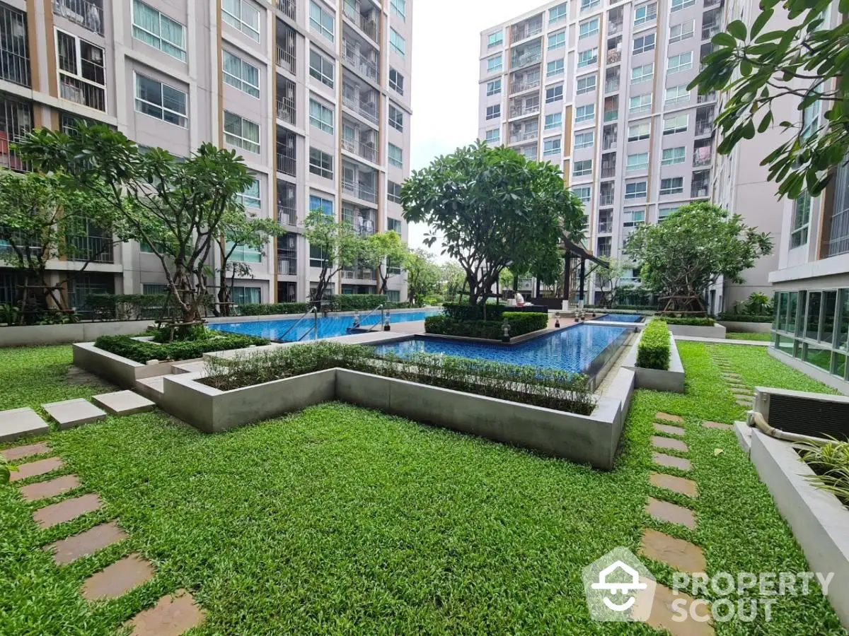 Luxurious condominium with lush garden and sparkling pool view