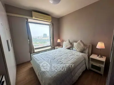 Cozy bedroom with city view, featuring a comfortable bed and stylish decor, perfect for relaxation.