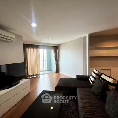 Modern living room with sleek furniture and balcony access