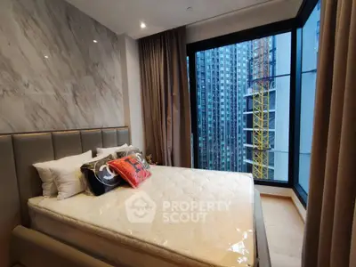Luxurious bedroom with floor-to-ceiling windows offering stunning city views in a modern high-rise apartment.