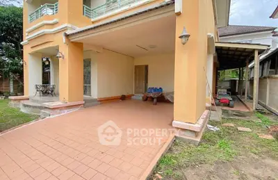 Charming two-story home with spacious covered patio and garden area, perfect for outdoor living.