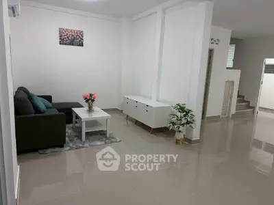 Spacious living room with modern decor and sleek tile flooring