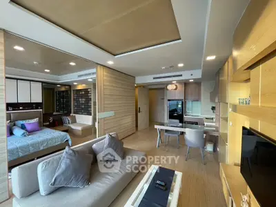Luxurious open-plan living room with modern kitchen and cozy bedroom in elegant apartment.
