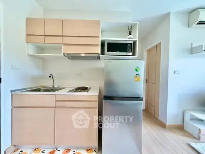 Modern compact kitchen with sleek appliances and minimalist design