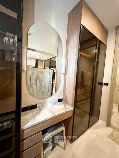 Modern bathroom with elegant marble vanity and sleek glass shower doors