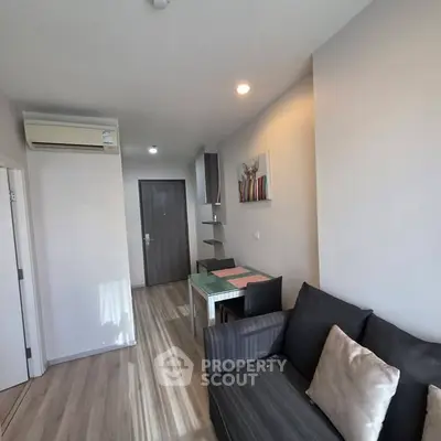 Modern living room with sleek design and cozy seating area in a stylish apartment.