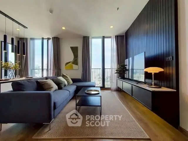 Modern living room with sleek design and city view, featuring a stylish sofa and elegant decor.