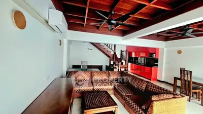 Spacious living room with wooden ceiling and modern furniture in a stylish home.