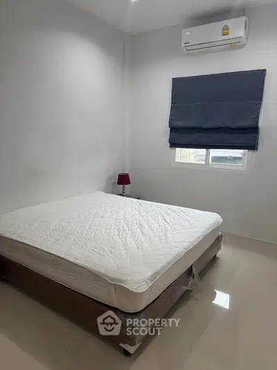 Cozy bedroom with air conditioning and modern decor, perfect for relaxation.