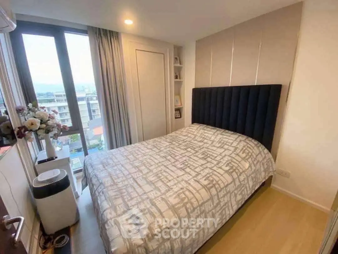 Cozy bedroom with modern decor and large window view