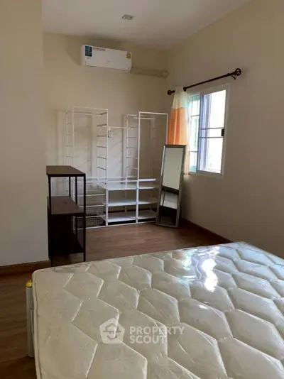 Spacious bedroom with natural light and modern furnishings