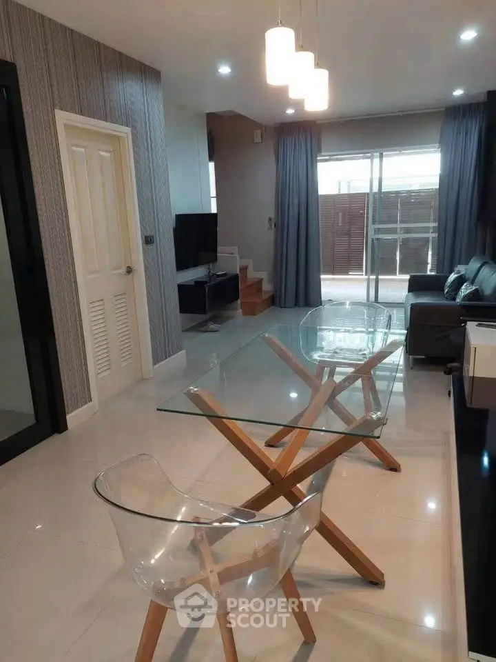 Modern living room with glass dining table and stylish decor