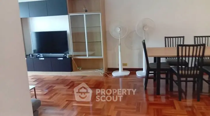 Spacious living room with elegant wooden flooring and modern furniture