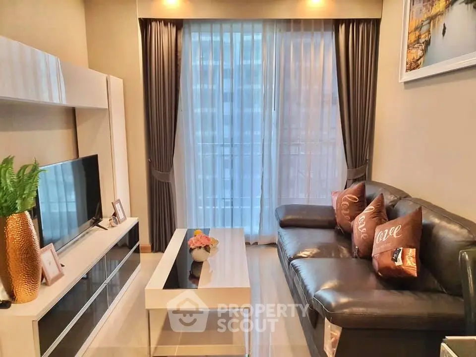 Modern living room with sleek furniture and large window, perfect for relaxation and entertainment.