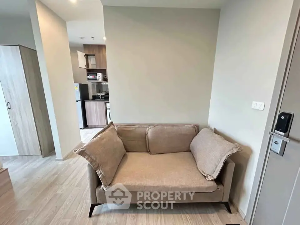 Cozy living area with modern kitchen in open layout apartment