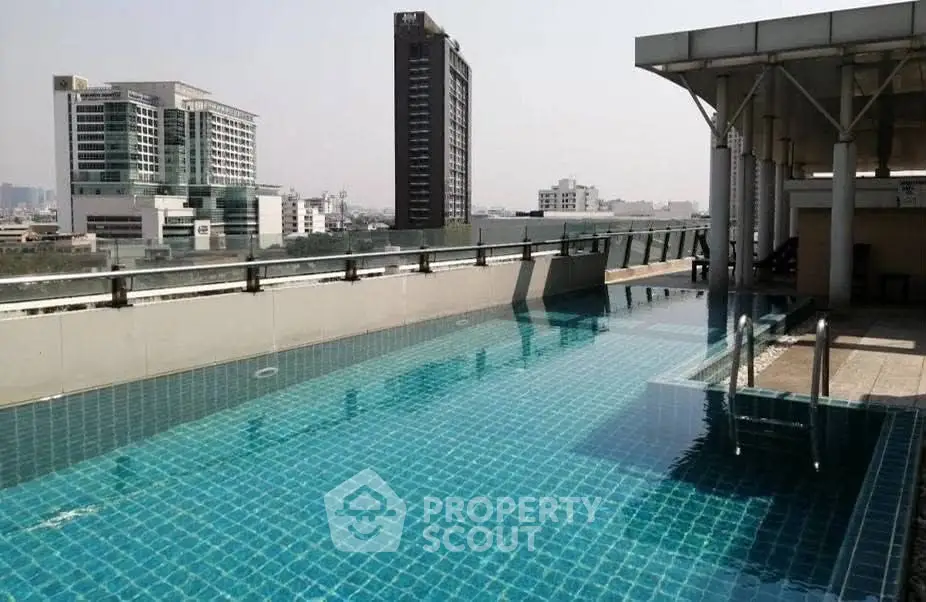 Stunning rooftop pool with city skyline views in modern urban setting.