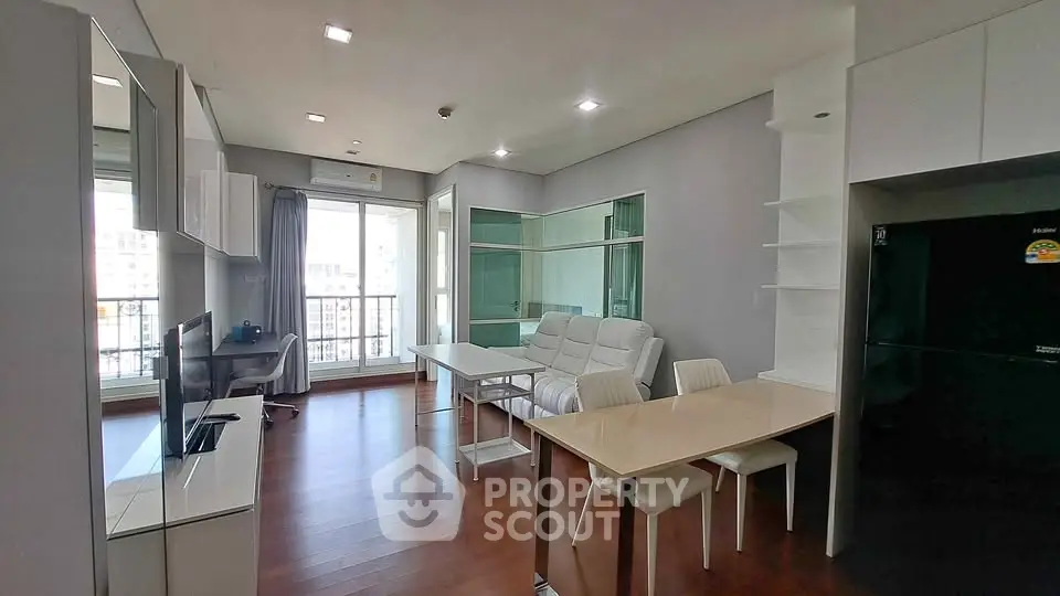 Modern living room with sleek furniture and large windows offering natural light