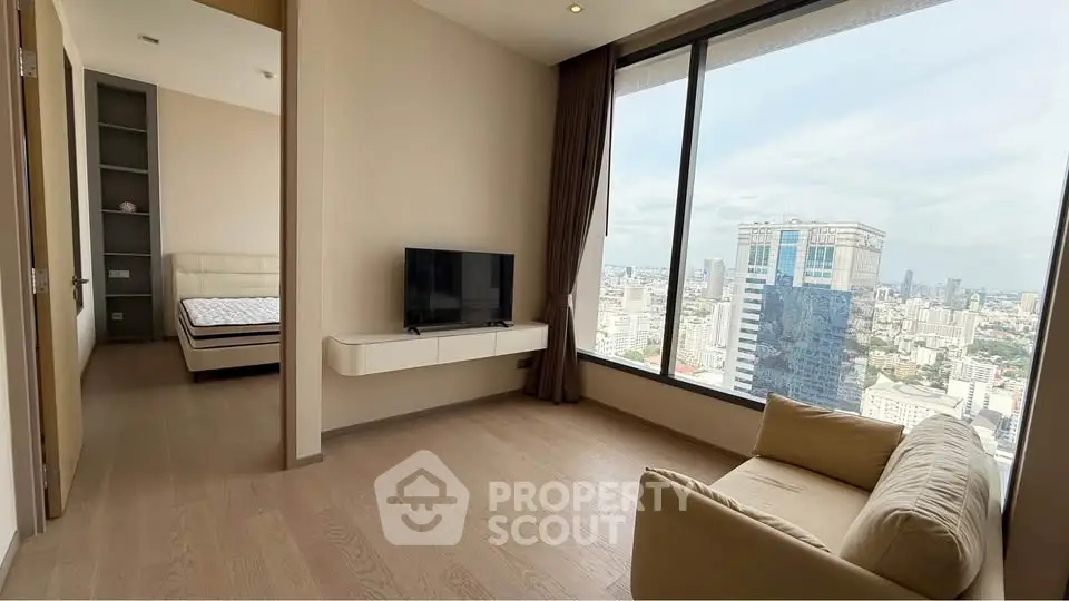 Modern living room with city view and adjacent bedroom in high-rise apartment