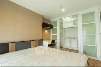 Spacious bedroom with modern design and built-in closet, perfect for comfortable living.