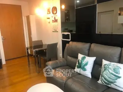 Modern living room with cozy leather sofa and dining area