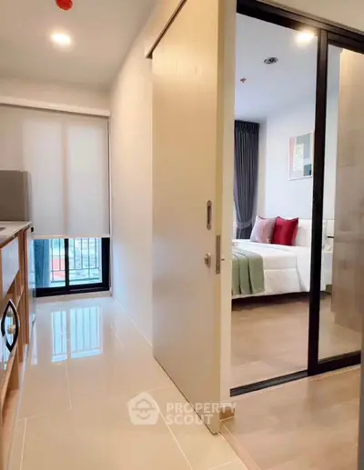 Modern apartment interior with sliding doors and cozy bedroom view.