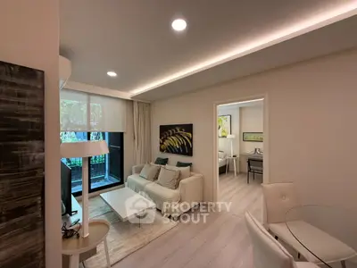 Modern living room with stylish decor and natural light in a contemporary apartment.