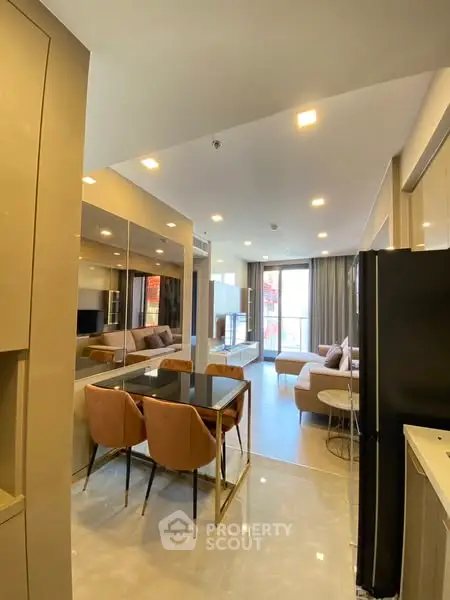 Modern open-layout living and dining area with stylish furniture and ample natural light.