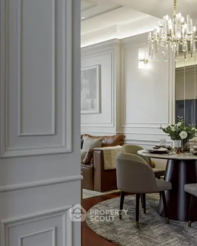 Elegant dining area with chandelier and modern decor in luxury apartment