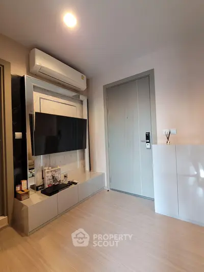 Modern living room with sleek TV setup and stylish air conditioning unit