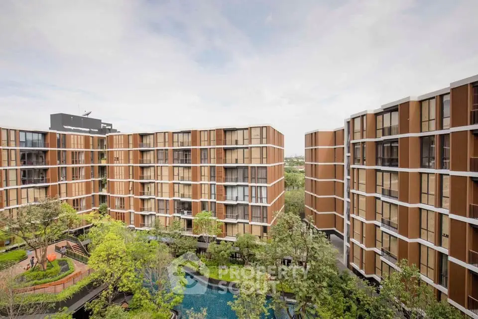 Modern apartment complex with lush greenery and pool view